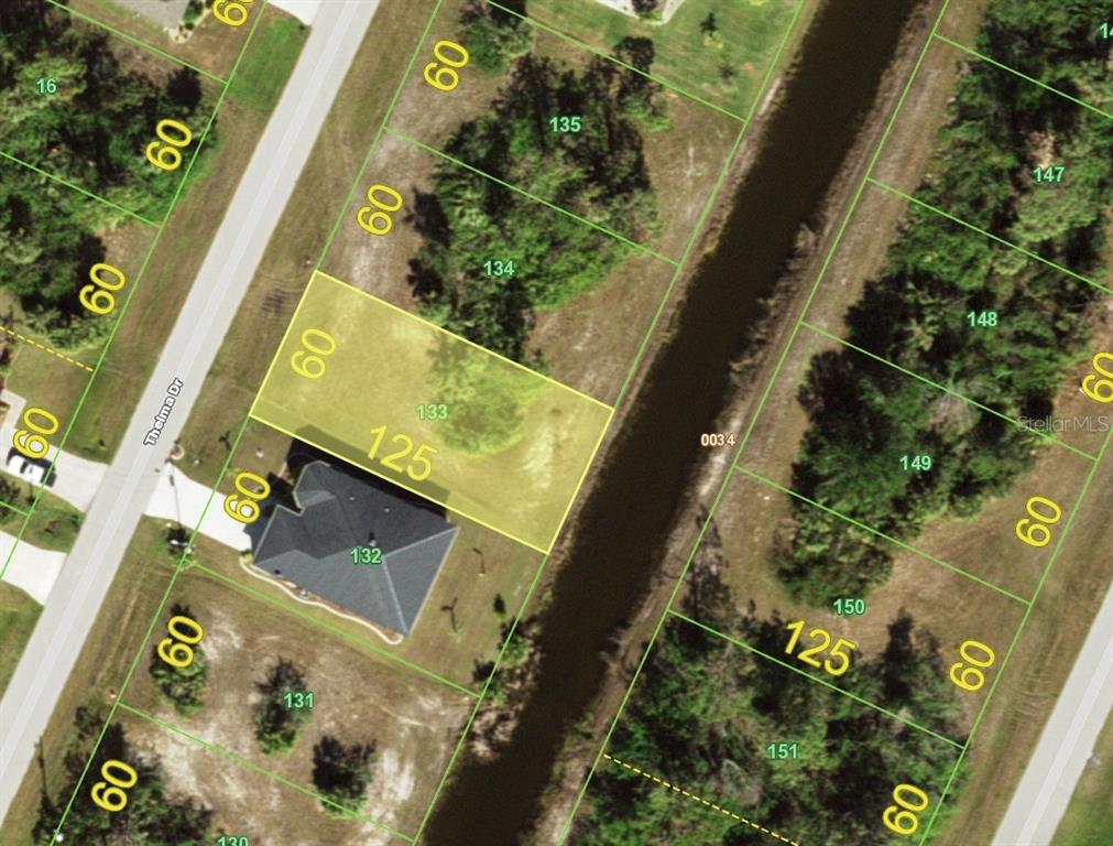 This is an aerial map showing a highlighted vacant residential lot next to a canal — 129 THELMA DRIVE, ROTONDA WEST, FL