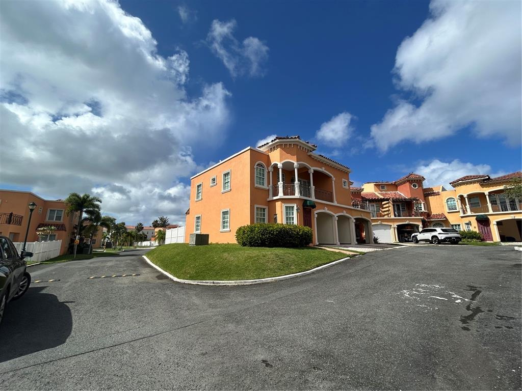 A two-story orange stucco building with a corner lot and a paved driveway — C11 BRIGHTON COUNTRY CLUB, DORADO, PR