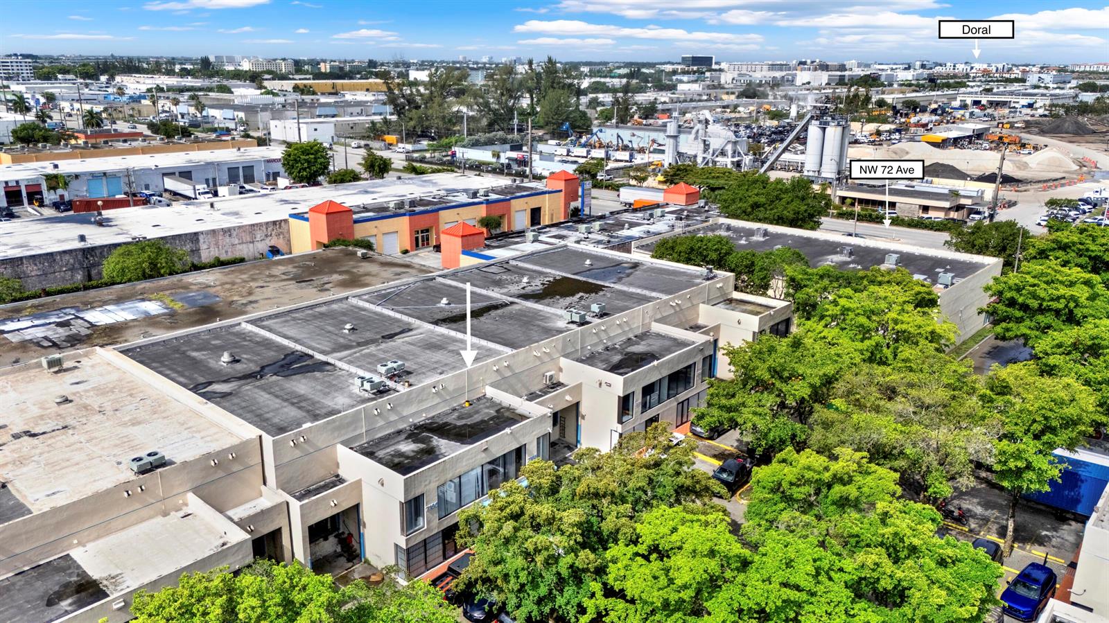 An aerial view shows a commercial warehouse building with a flat roof and surrounding trees — 7168 NW 50th Street, Miami FL 33166, MIAMI, FL
