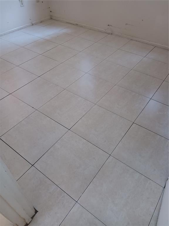 A room with light-colored square floor tiles and plain white walls — 1906 HONOUR ROAD UNIT 2, ORLANDO, FL