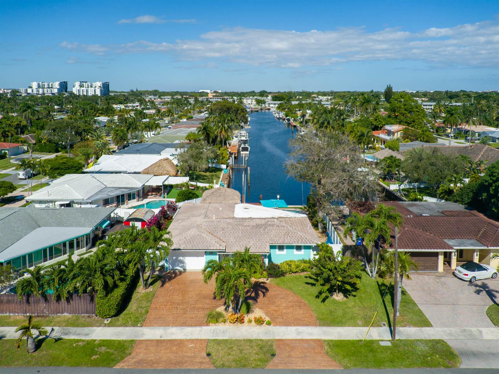 An aerial view shows a waterfront house with a tiled roof, pool, and boat dock — 521 SE 4 Court, Pompano Beach FL 33060, POMPANO BEACH, FL