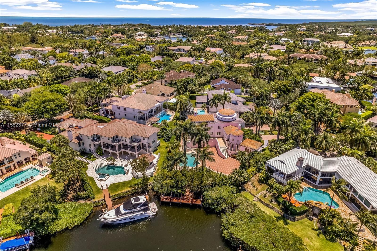 An aerial view shows multiple waterfront luxury homes with swimming pools and private boat docks — 431 Costanera Rd, Coral Gables FL 33143, CORAL GABLES, FL