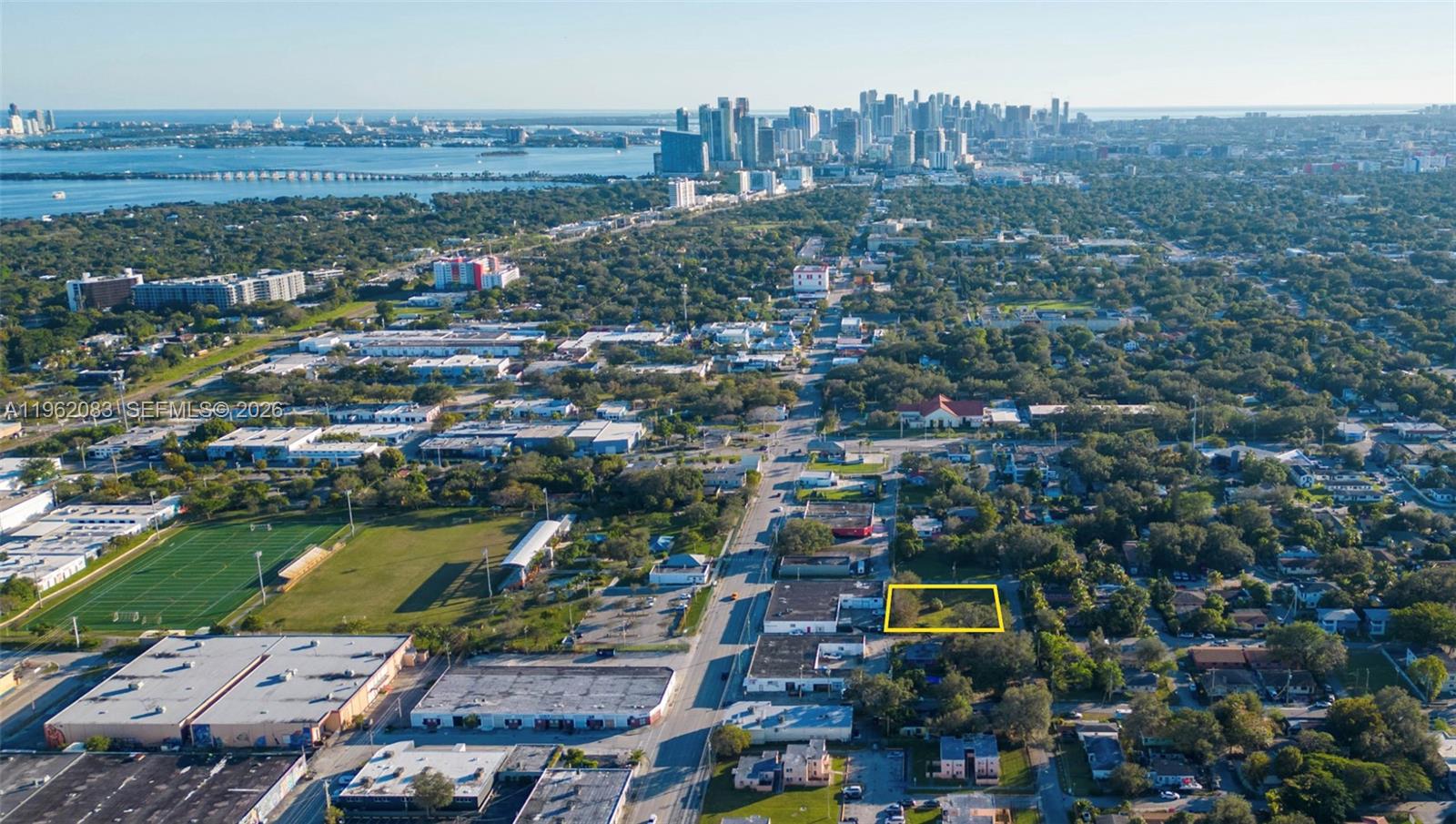 An aerial view shows a vacant rectangular lot highlighted in yellow within a suburban area — 159 NE 64th St, Miami FL 33138, MIAMI, FL