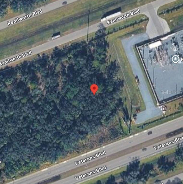 This aerial map view shows a wooded lot situated between two roads and a utility substation — 20383 KENILWORTH BOULEVARD, PORT CHARLOTTE, FL