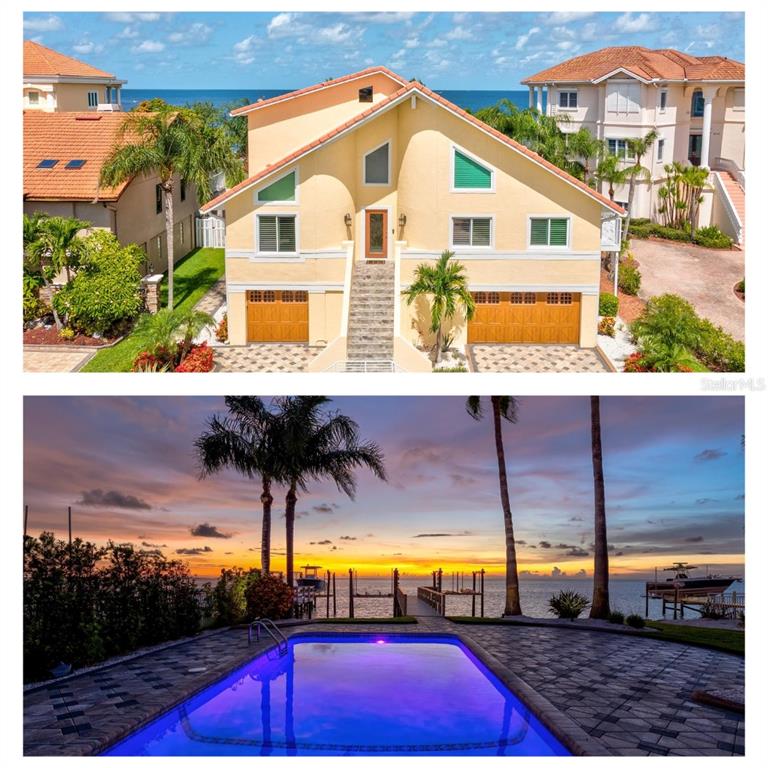 A stone-tiled balcony with a white railing overlooks a backyard, swimming pool, and the ocean — 5101 WESTSHORE DRIVE, NEW PORT RICHEY, FL