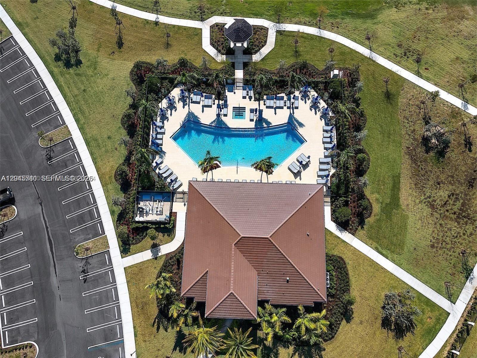An aerial view shows a community clubhouse with a swimming pool, patio, and parking lot — 10100 SW 228 Terrace, Miami FL 33190, MIAMI, FL