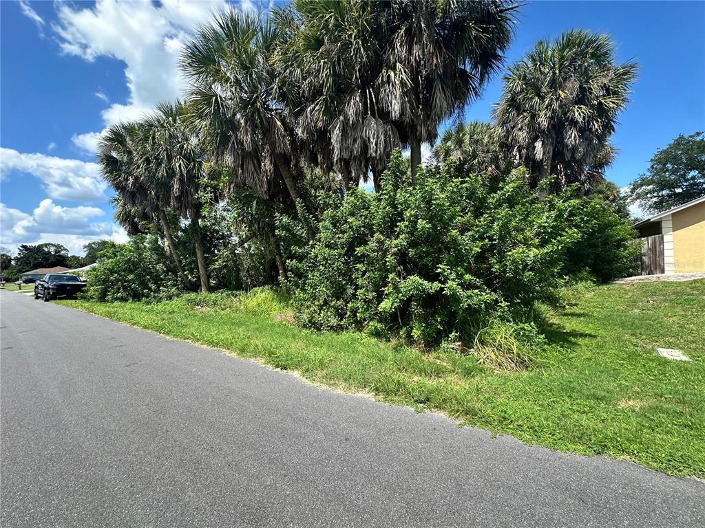 This is an aerial map view of a vacant residential lot highlighted in yellow — 18394 GOODMAN CIRCLE, PORT CHARLOTTE, FL