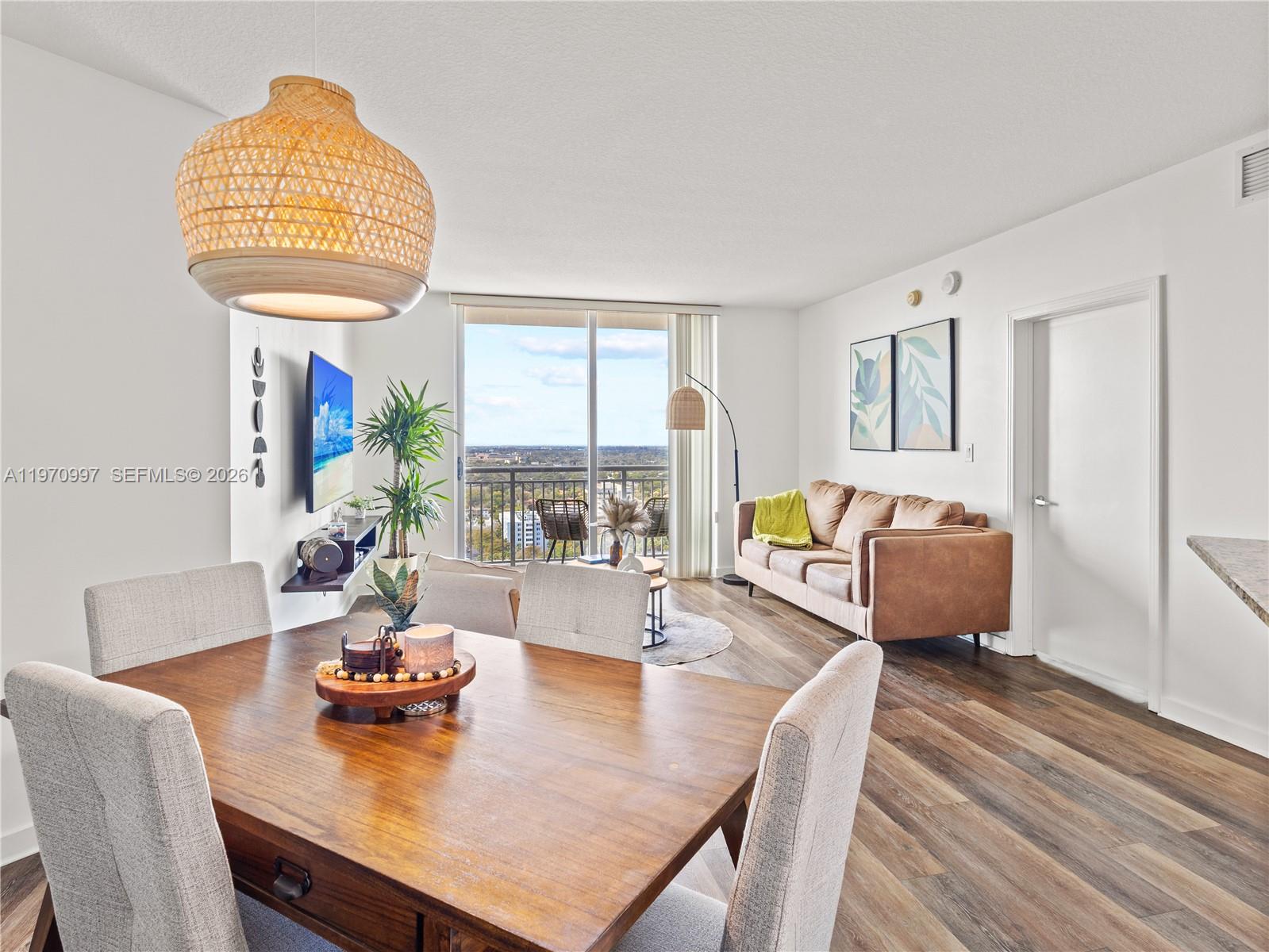 A dining area opens into a living room with a balcony and city views — 9066 SW 73rd Ct # 2008, Miami FL 33156, MIAMI, FL