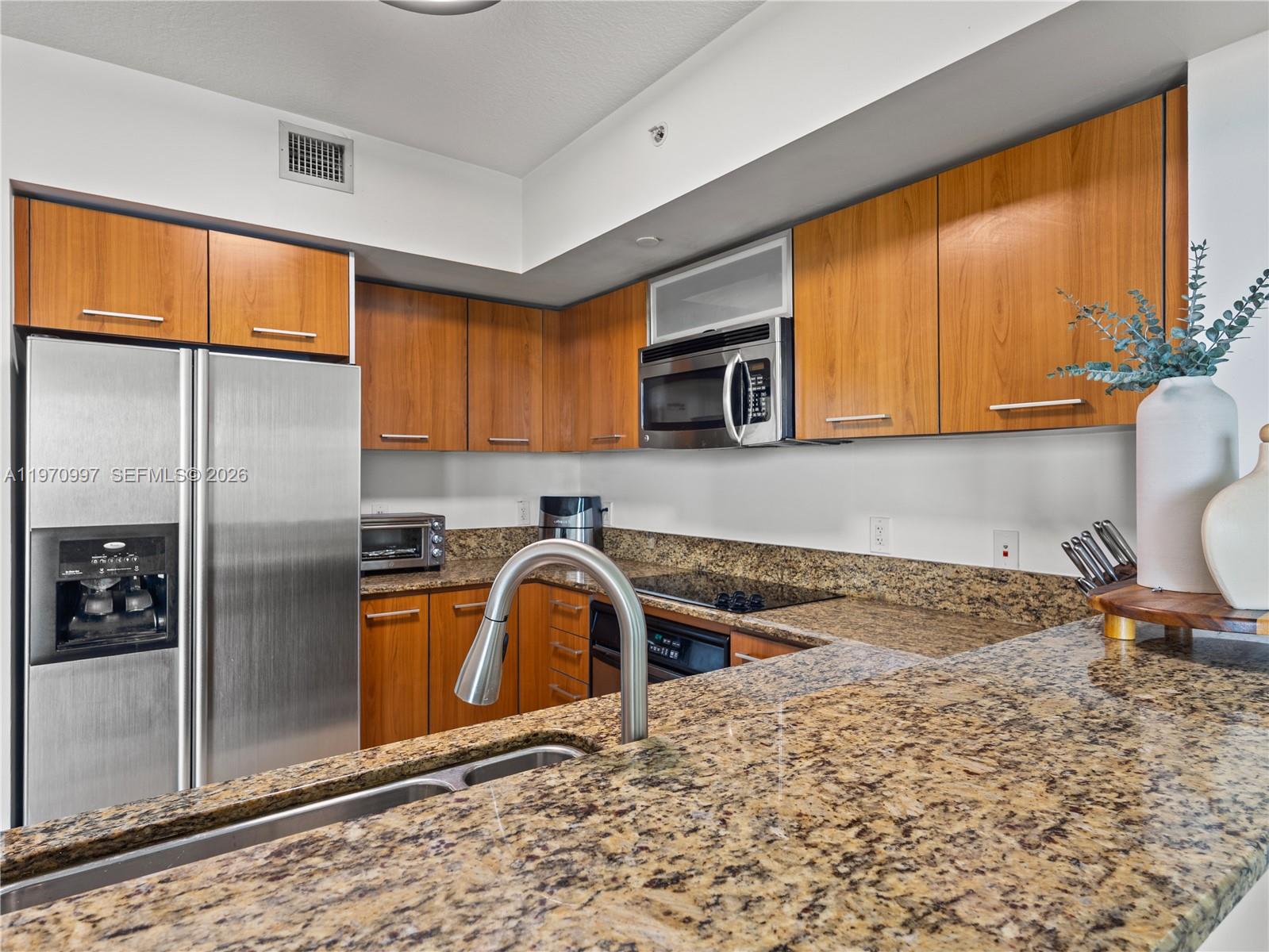 A kitchen features wood cabinets, granite countertops, stainless steel appliances, and a double sink — 9066 SW 73rd Ct # 2008, Miami FL 33156, MIAMI, FL