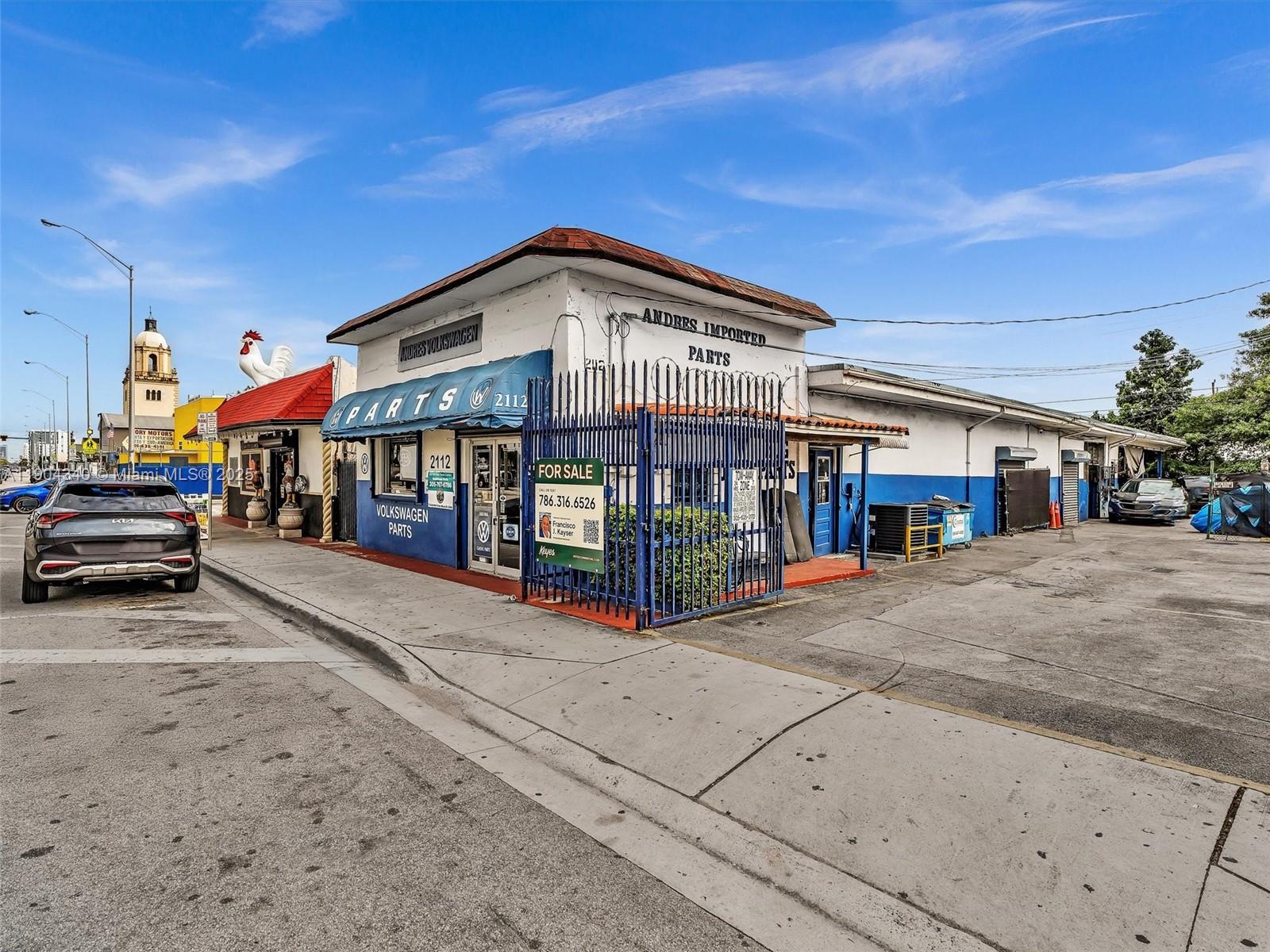 A corner commercial building with blue and white paint is listed for sale — 2112 NW 36th St, Miami FL 33142, MIAMI, FL
