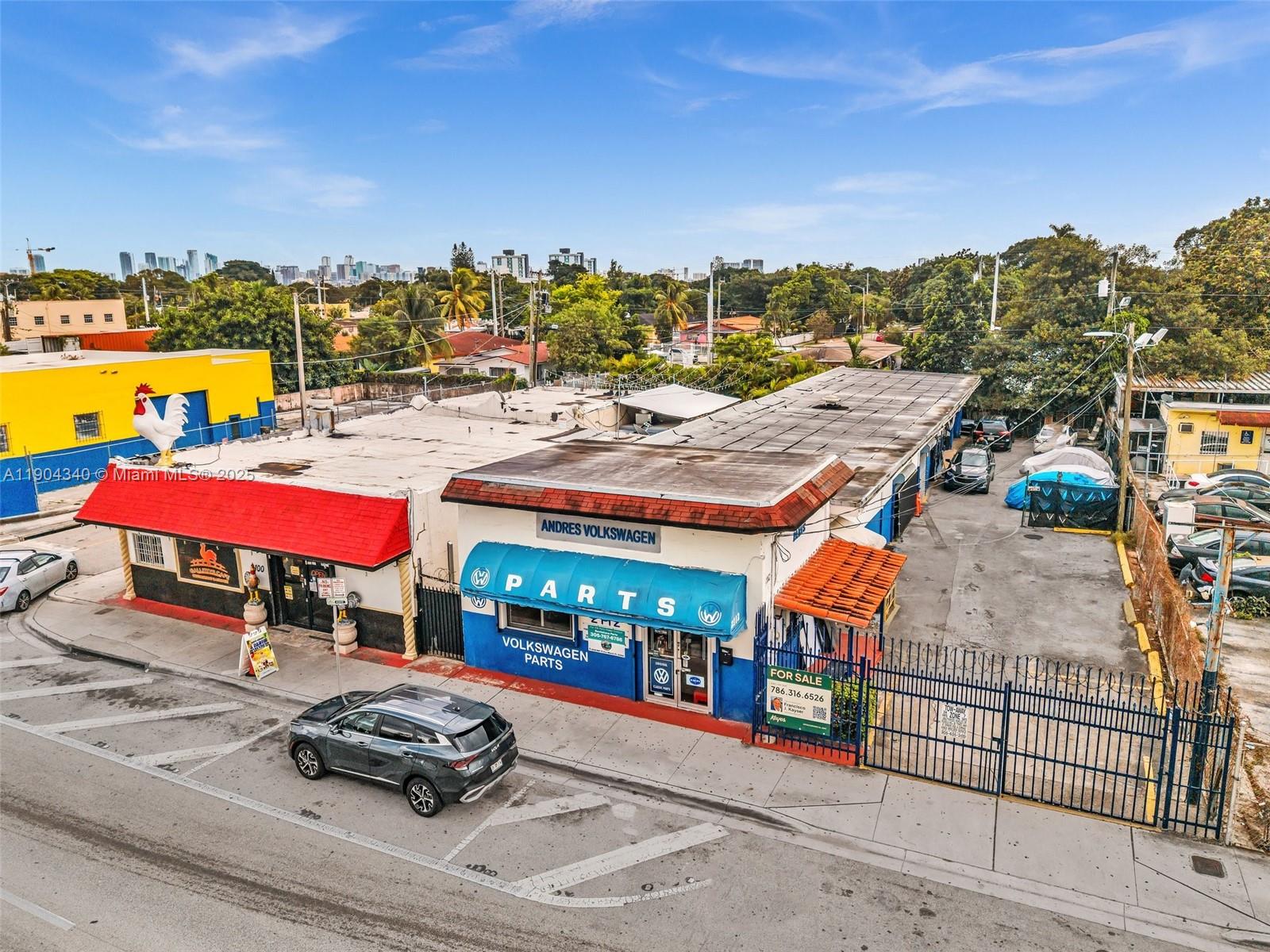 An aerial view shows a commercial building with a Volkswagen parts shop and adjacent restaurant — 2112 NW 36th St, Miami FL 33142, MIAMI, FL
