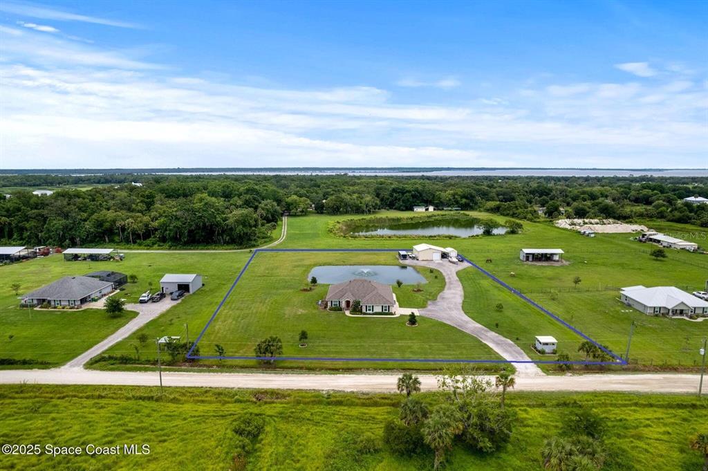 A single-story house with light blue siding, a white garage door, and a grassy lawn — 3088 WAINWRIGHT STREET, DELTONA, FL
