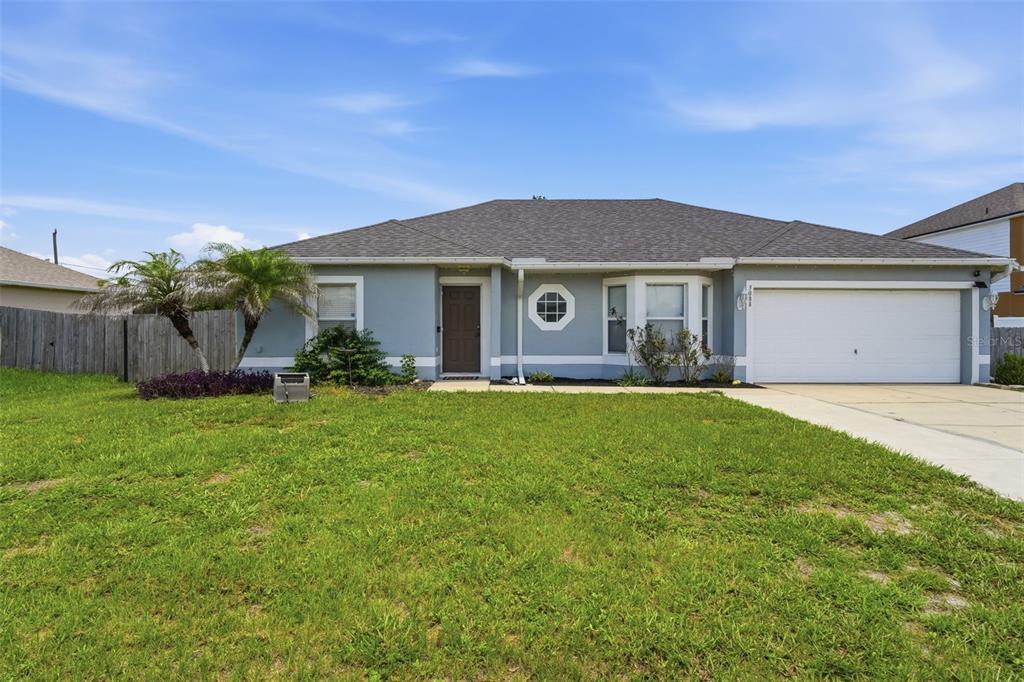 A single-story house with a gray exterior, a two-car garage, and a front lawn — 3088 WAINWRIGHT STREET, DELTONA, FL