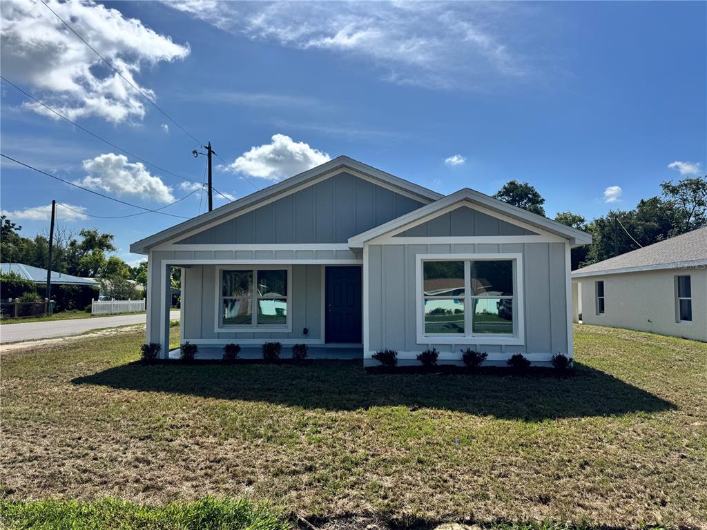 A single-story house with light gray vertical siding and a covered front porch — 6024 12TH STREET, ZEPHYRHILLS, FL
