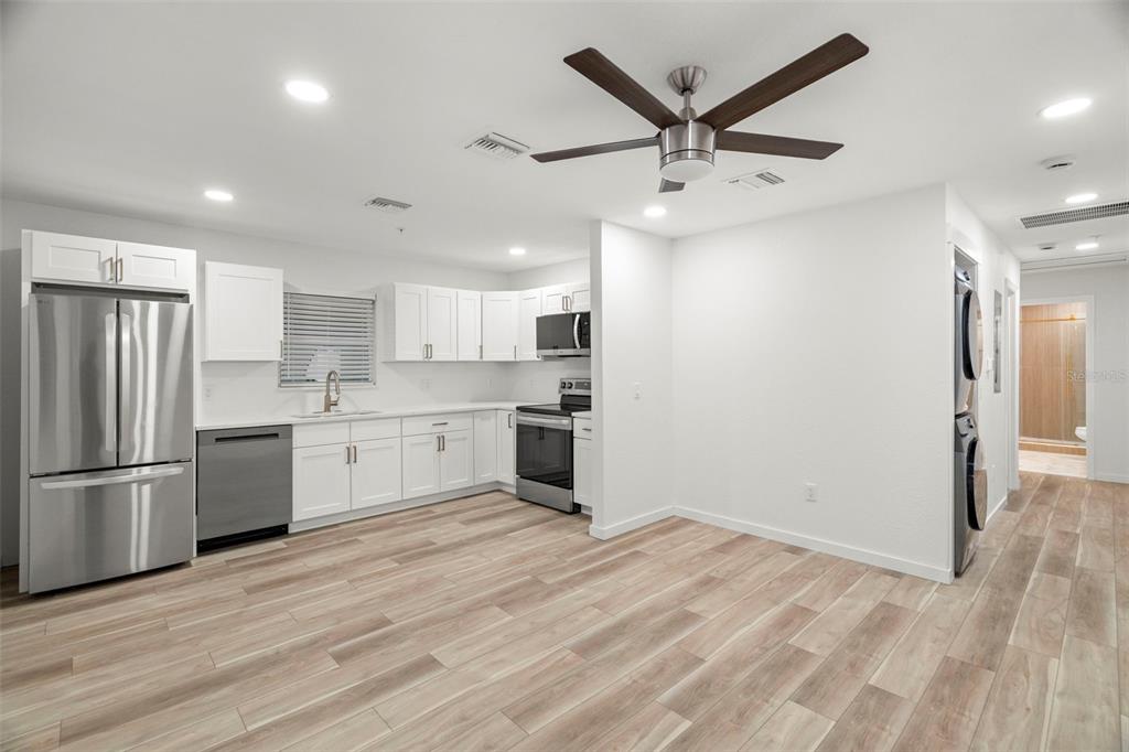 A kitchen with white cabinets, stainless steel appliances, and light wood-look flooring — 3103 16TH STREET N, ST PETERSBURG, FL
