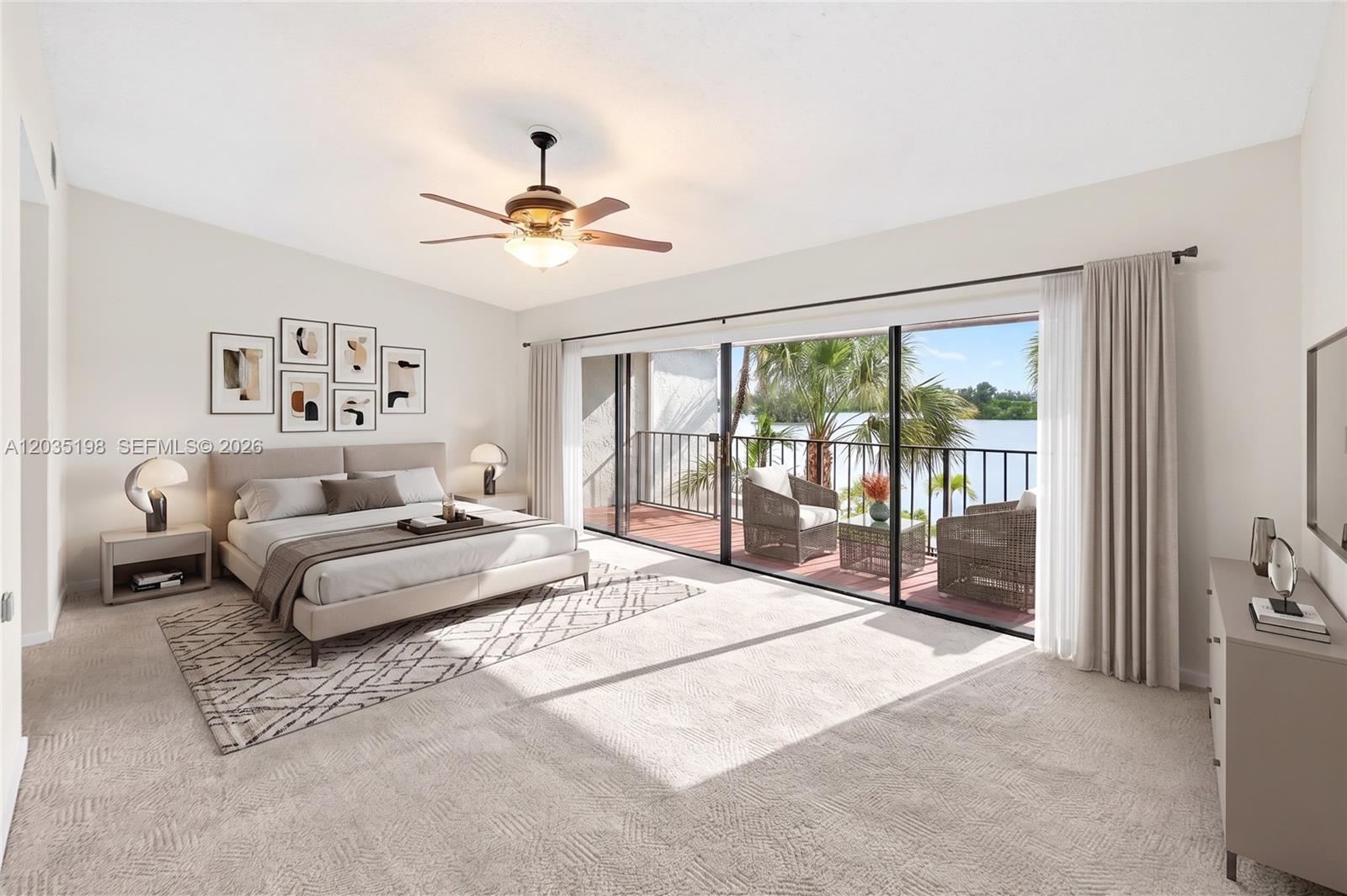A bedroom features a bed, ceiling fan, and sliding glass doors opening to a balcony — 5002 SW 72nd Ave, Miami FL 33155, MIAMI, FL