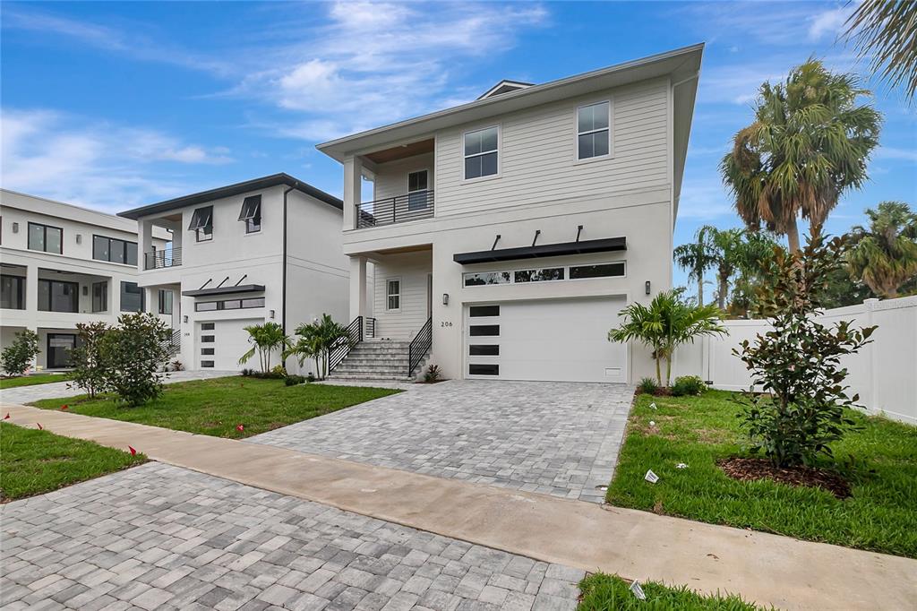 A two-story modern house with a white exterior, a two-car garage, and a paved driveway — 206 CHIPPEWA AVENUE, TAMPA, FL