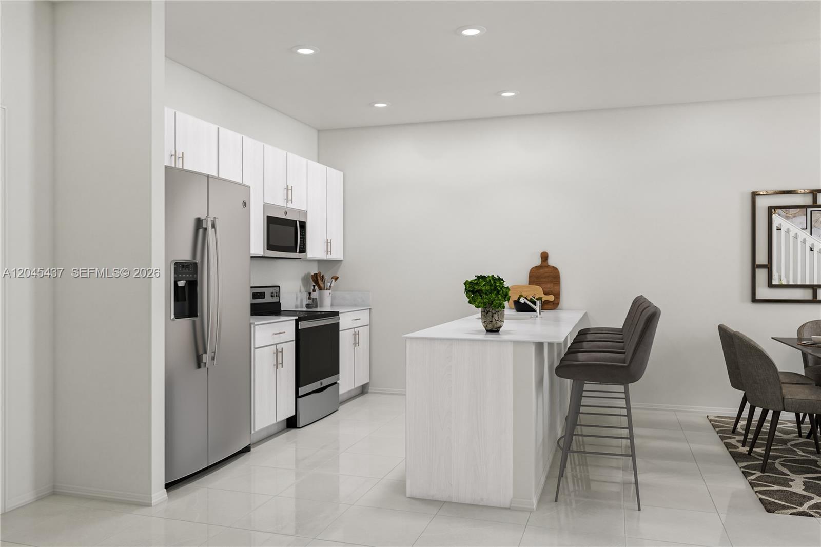 A modern kitchen features white cabinetry, stainless steel appliances, and a central island with seating — MIAMI, FL