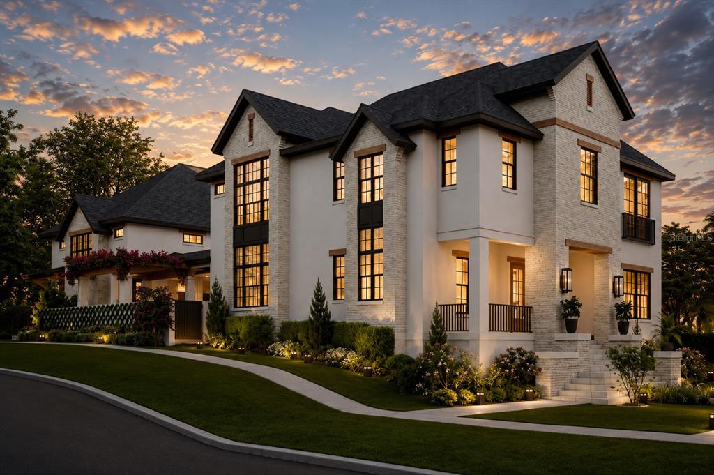 A multi-story house with white stucco, stone accents, and dark window frames at sunset — 2313 N RIVERSIDE DRIVE, TAMPA, FL