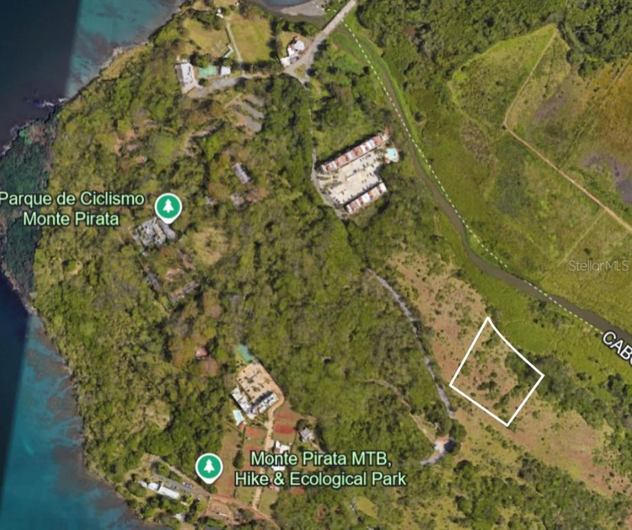 This is an aerial map showing a plot of land highlighted in white near a park — 102 KM 8.2, GUANAJIBO WARD ROAD UNIT C-6, CABO ROJO, PR