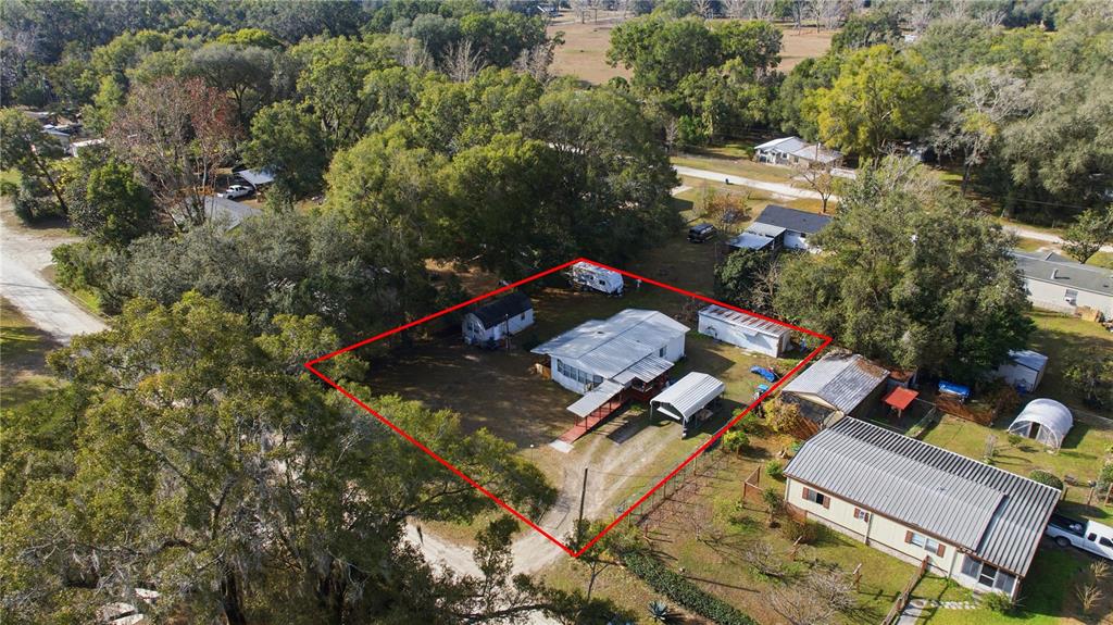 An aerial view shows a residential lot with a house, outbuildings, and trees — 6520 NE 23RD AVENUE, OCALA, FL