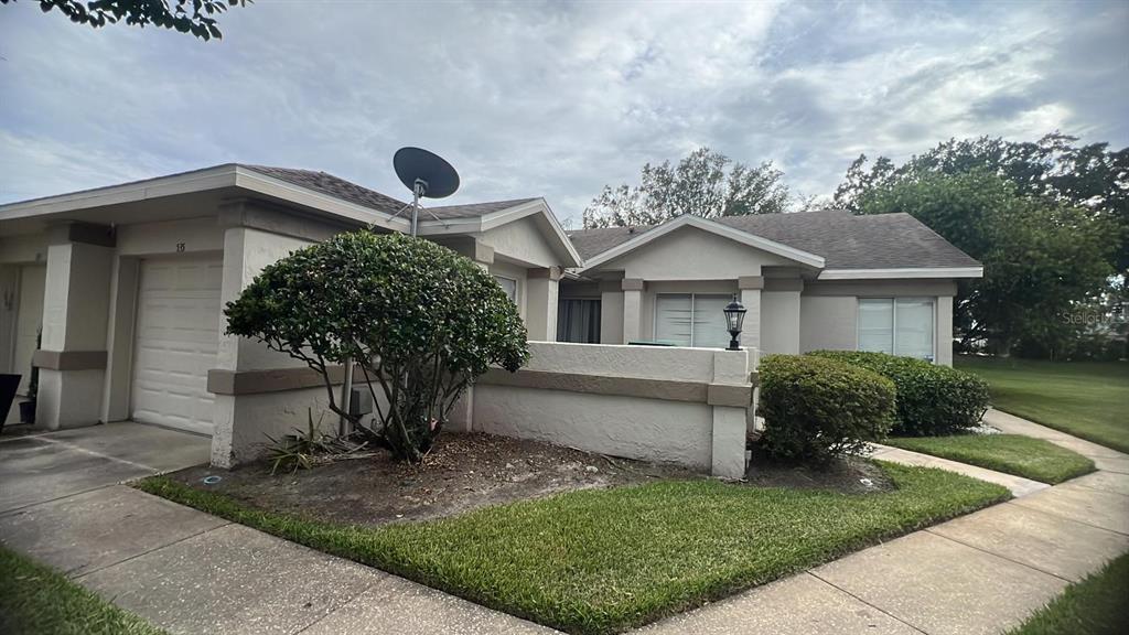 A single-story house with a garage, a small front yard, and a satellite dish — 535 AZINGER CIRCLE UNIT 16, ORLANDO, FL