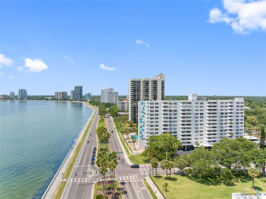 An aerial view shows a coastal road running alongside a bay with several high-rise buildings — 2401 BAYSHORE BLVD UNIT 502, TAMPA, FL