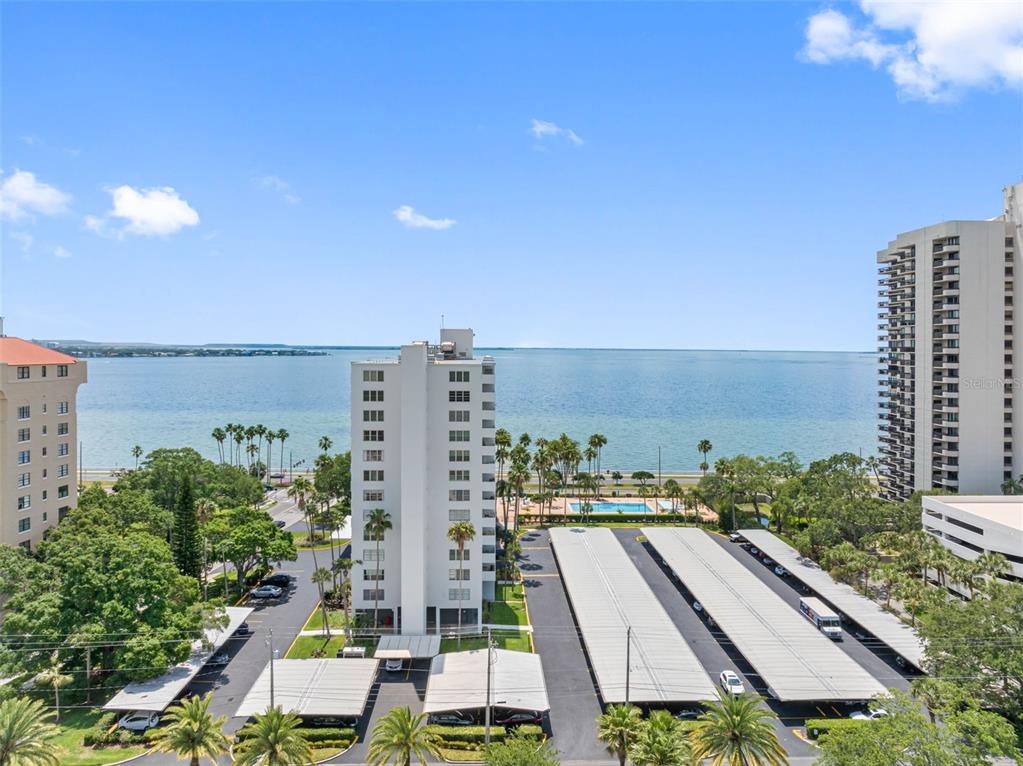 An elevated view of a high-rise apartment complex with parking structures overlooking the ocean — 2401 BAYSHORE BLVD UNIT 502, TAMPA, FL