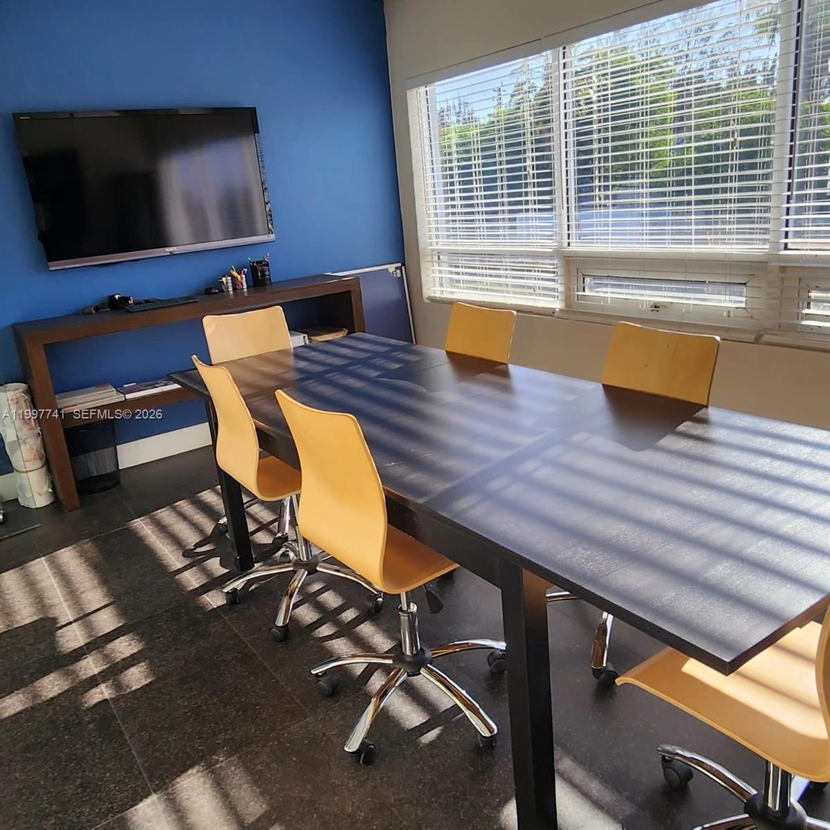 A conference room features a dark table, yellow chairs, a blue wall, and large windows — 2441 NW 93 # B, Doral FL 33172, DORAL, FL