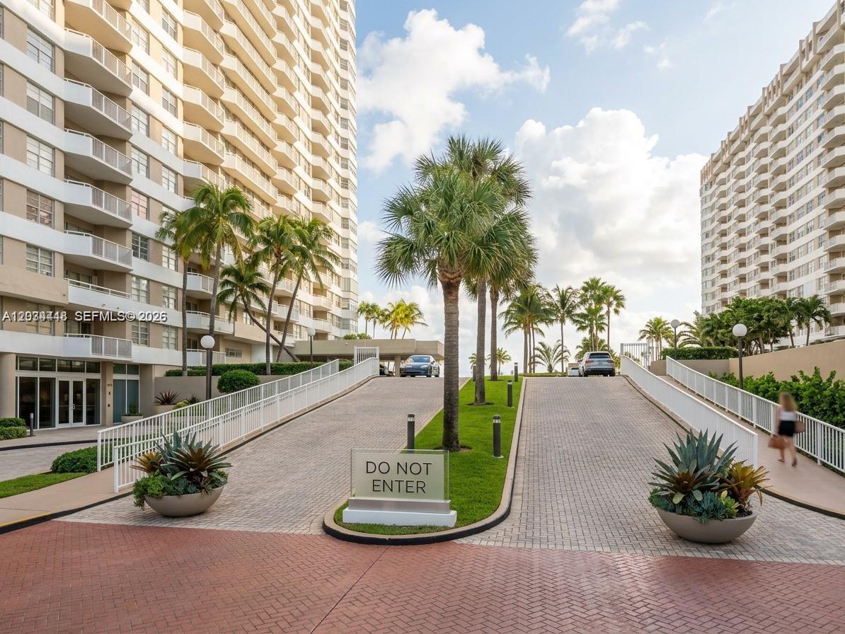 A paved driveway with a Do Not Enter sign leads between two large residential buildings — 1985 S Ocean Dr # 2B, Hallandale Beach FL 33009, HALLANDALE BEACH, FL