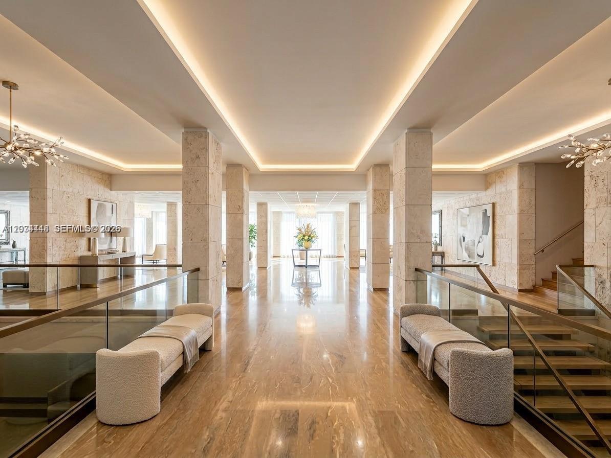 A spacious, modern lobby features marble floors, recessed ceiling lighting, and two upholstered benches — 1985 S Ocean Dr # 2B, Hallandale Beach FL 33009, HALLANDALE BEACH, FL