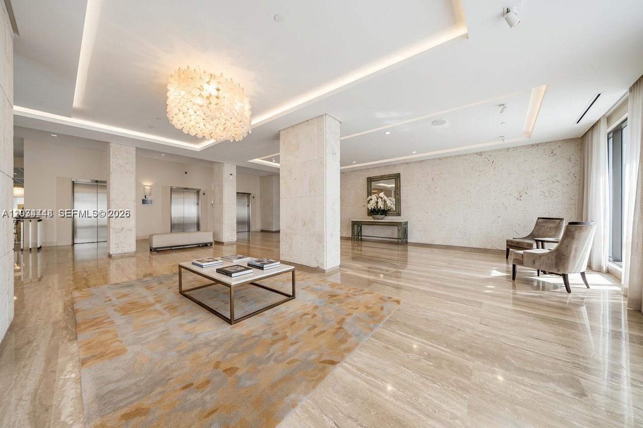A spacious lobby features marble floors, a central rug with a coffee table, and elevators — 1985 S Ocean Dr # 2B, Hallandale Beach FL 33009, HALLANDALE BEACH, FL