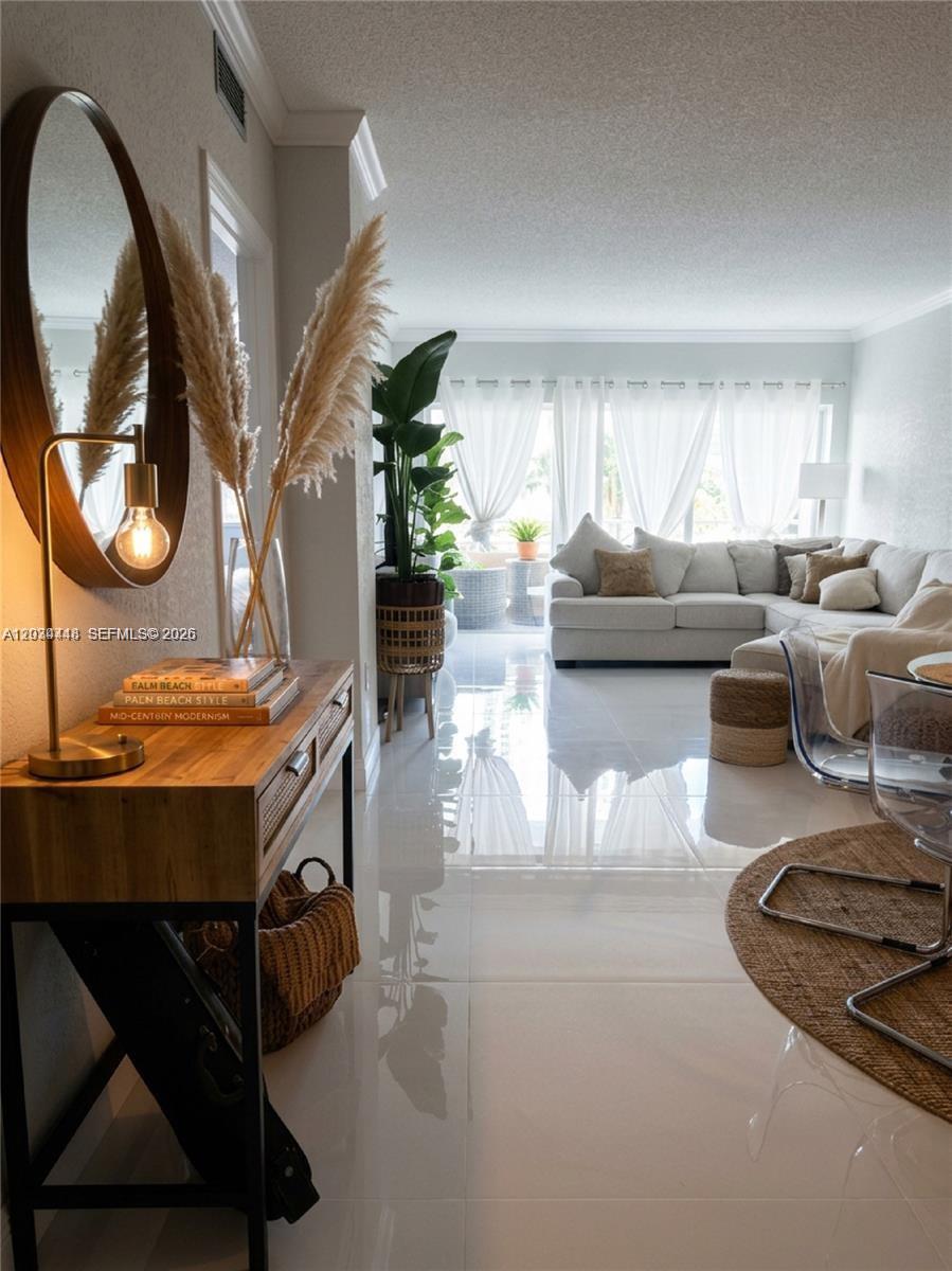A bright living room features white tile floors, a sectional sofa, and a wooden console table — 1985 S Ocean Dr # 2B, Hallandale Beach FL 33009, HALLANDALE BEACH, FL