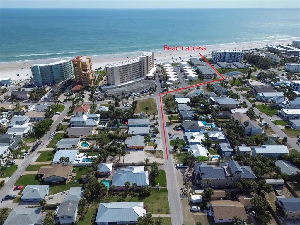 An aerial view shows a coastal neighborhood with a red line indicating beach access — 306 NORMANDY AVENUE, NEW SMYRNA BEACH, FL