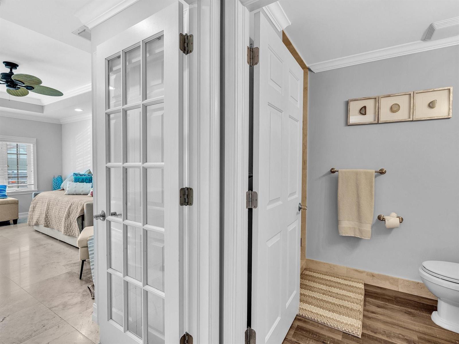 A view through two open doors showing a bedroom and a bathroom with light flooring — 3602 S Ocean Boulevard # 102, Highland Beach FL 33487, HIGHLAND BEACH, FL