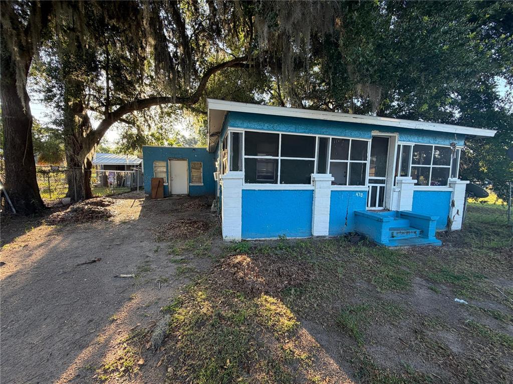 A bright blue, single-story house with a screened-in front porch and white trim — 470 S EAST AVENUE, BARTOW, FL