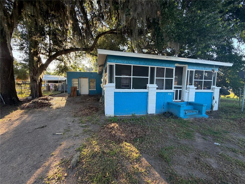 A bright blue, single-story house with a screened-in front porch and white trim — 470 S EAST AVENUE, BARTOW, FL