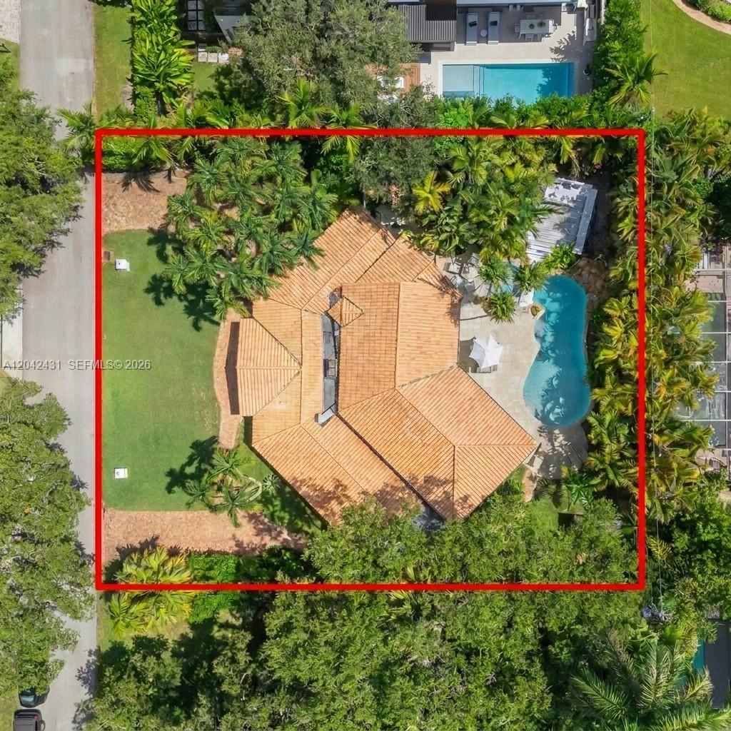 An aerial view of a house with a tile roof, pool, and lawn inside a lot — 7924 SW 50th Ct, Miami FL 33143, MIAMI, FL