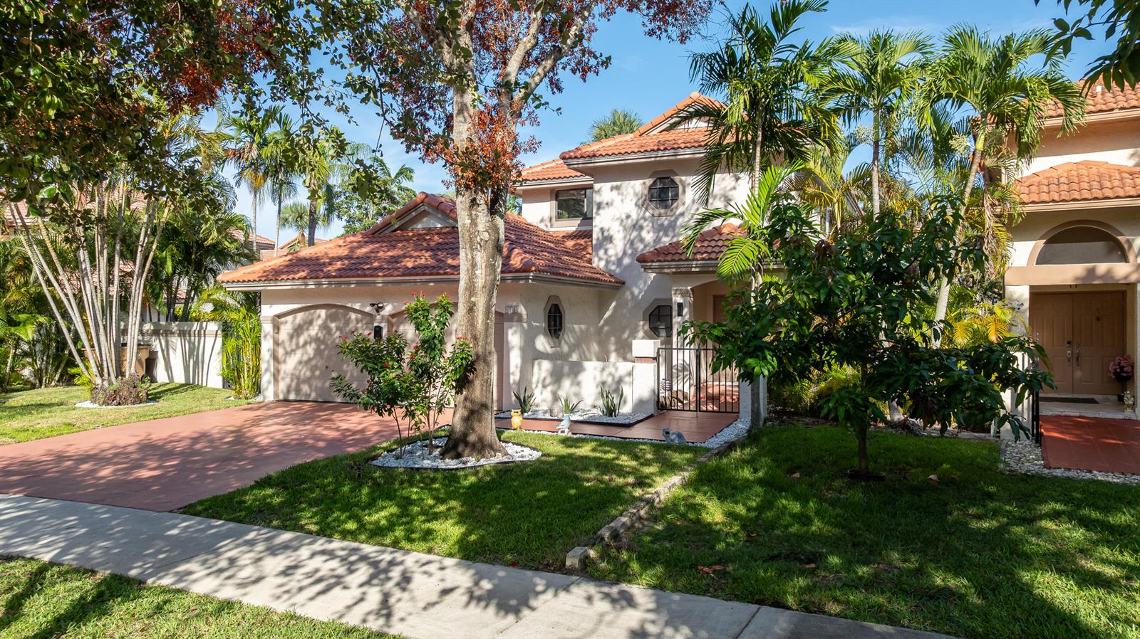 A two-story house with a tiled roof, a garage, and a landscaped front yard — 484 NW 38th Terrace, Deerfield Beach FL 33442, DEERFIELD BEACH, FL