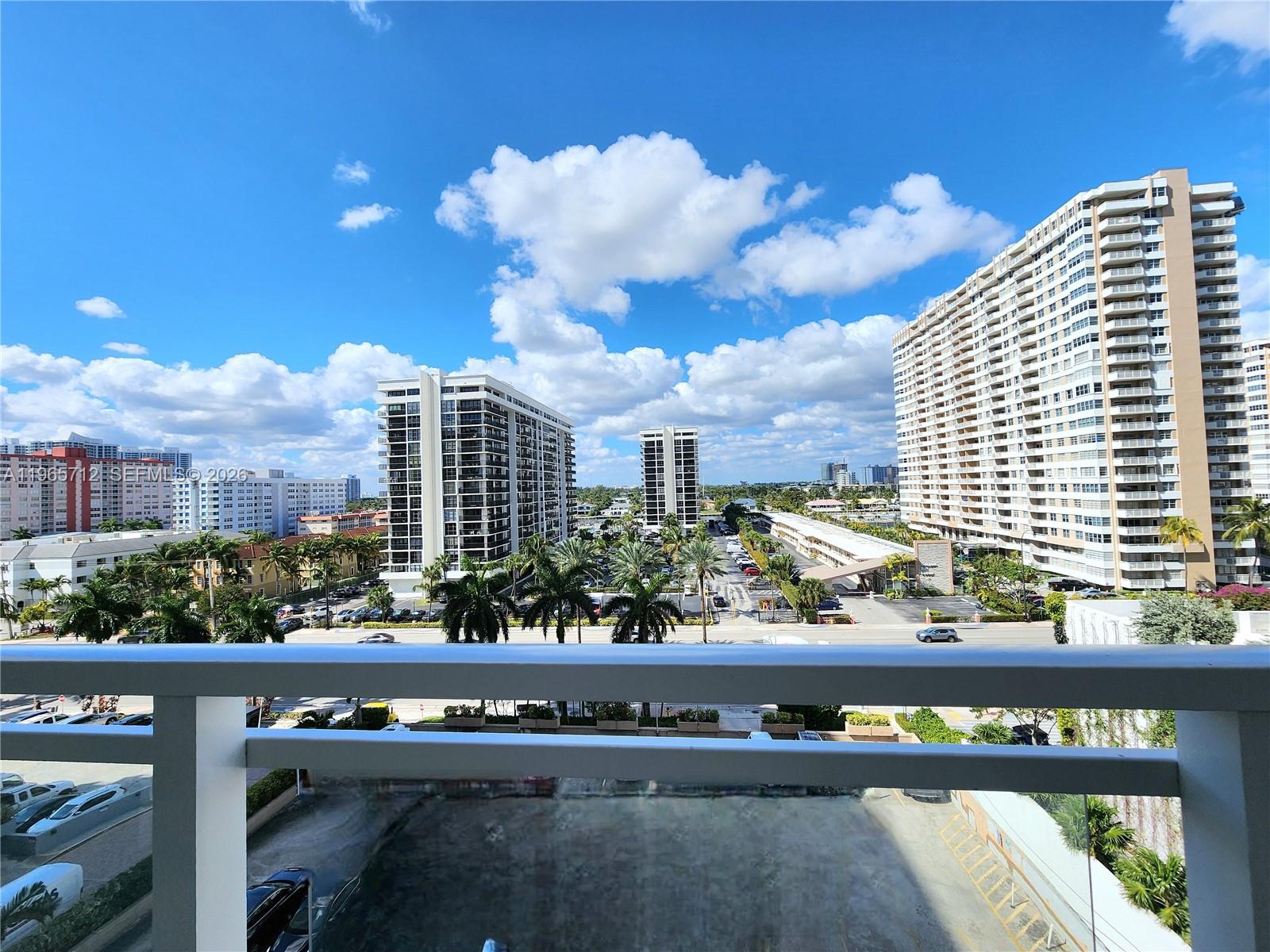 An elevated view from a balcony overlooks a parking lot and several high-rise apartment buildings — 2030 S Ocean Dr # 626, Hallandale Beach FL 33009, HALLANDALE BEACH, FL