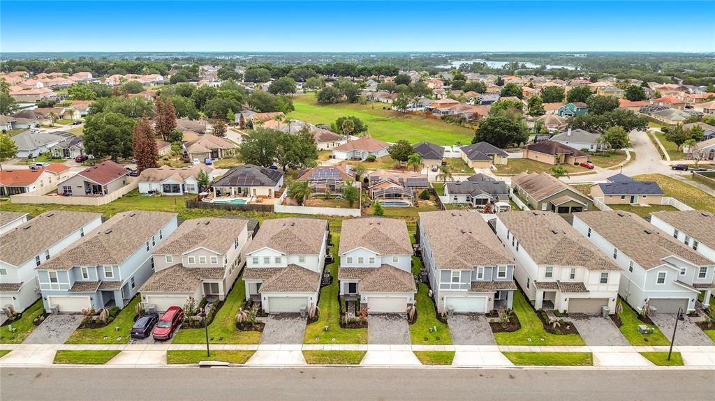 A dark blue six-panel front door is set in a light-colored stucco exterior wall — 3859 LANA AVENUE, DAVENPORT, FL