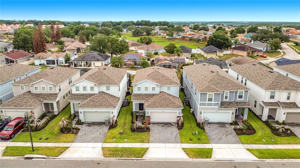 An entryway features a white front door, a tiled floor, and a built-in mudroom bench — 3859 LANA AVENUE, DAVENPORT, FL