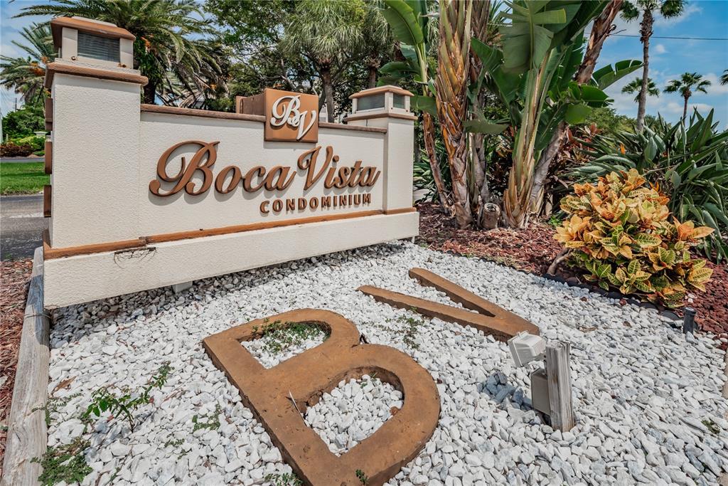 A beige monument sign for Boca Vista Condominium sits in a landscaped garden bed — 401 150TH AVENUE UNIT 245, MADEIRA BEACH, FL