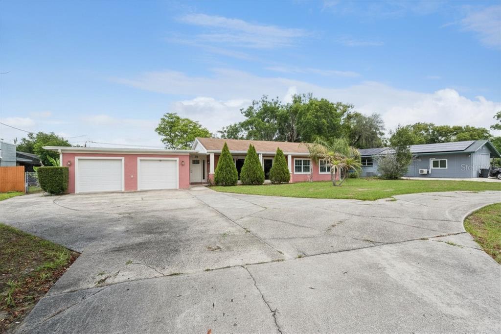 A single-story house with a two-car garage and a large, cracked concrete driveway — 78 S WINTER PARK DRIVE, CASSELBERRY, FL
