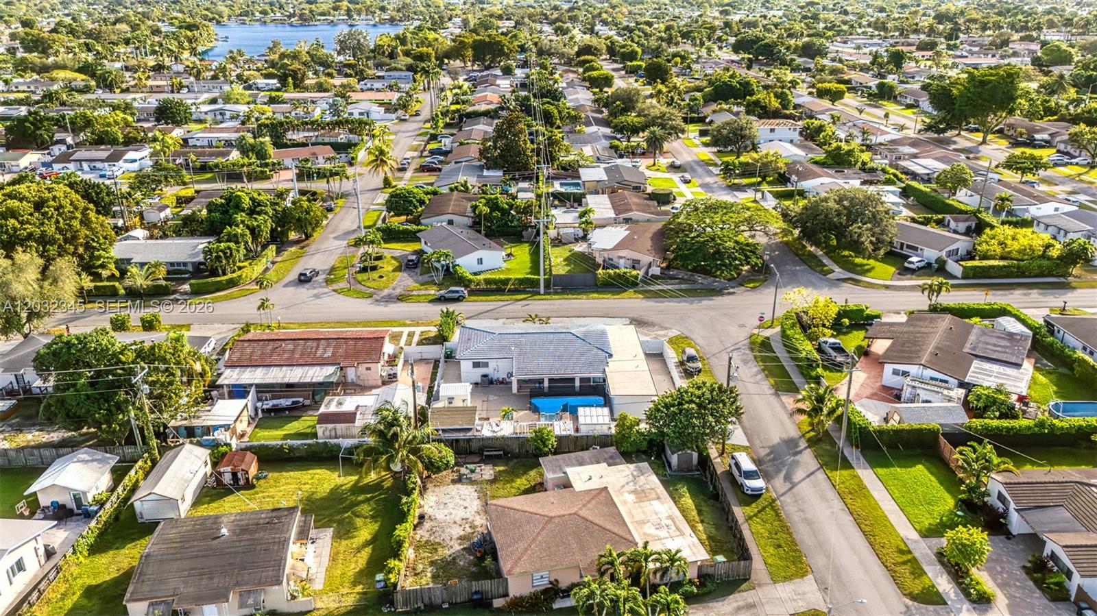 An aerial view shows a residential neighborhood with houses, swimming pools, and tree-lined streets — 9365 SW 44th St, Miami FL 33165, MIAMI, FL
