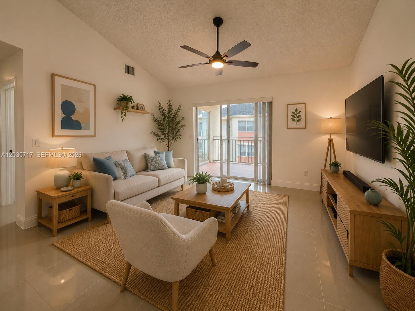 A living room features a beige sofa, armchair, wooden coffee table, and a wall-mounted television — 18840 NW 57th Ave # 302, Hialeah FL 33015, HIALEAH, FL