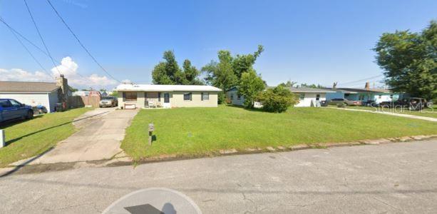 A single-story house with a light-colored exterior and a concrete driveway sits on a lawn — 810 FORESTDALE AVENUE, PANAMA CITY, FL