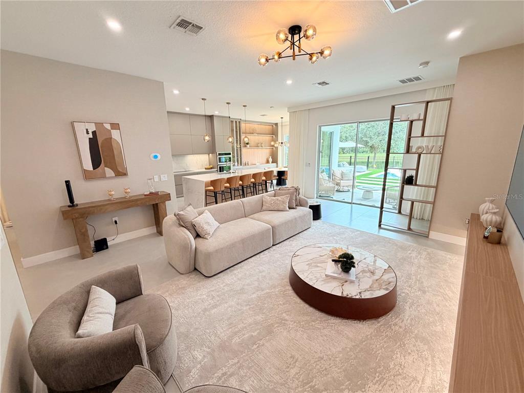 A single-story house features a white stucco exterior, a paver driveway, and a two-car garage — 12676 SALOMON COVE DRIVE, WINDERMERE, FL