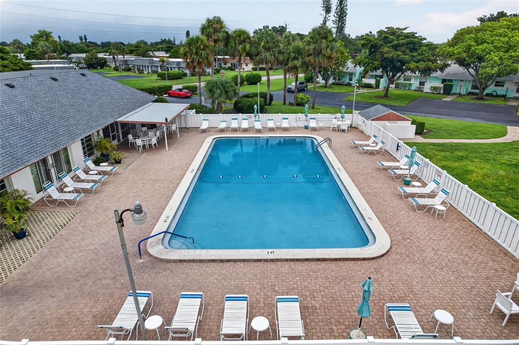 An aerial view of a rectangular swimming pool surrounded by lounge chairs and a patio — 3603 41ST STREET W UNIT 3603, BRADENTON, FL
