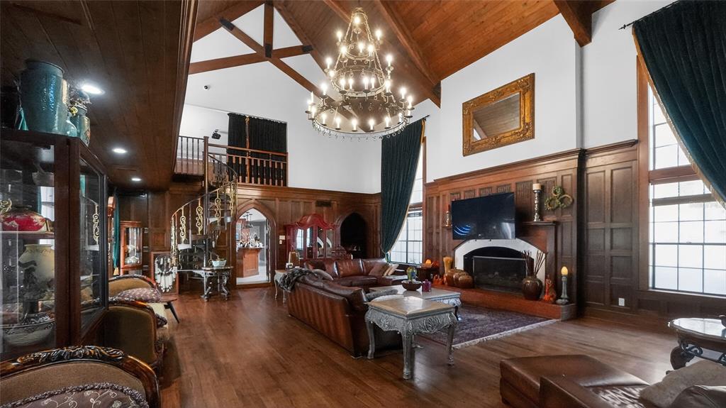A brick house exterior features a large paved courtyard, multiple garage doors, and a covered walkway — 810 SWEETWATER CLUB BOULEVARD, LONGWOOD, FL